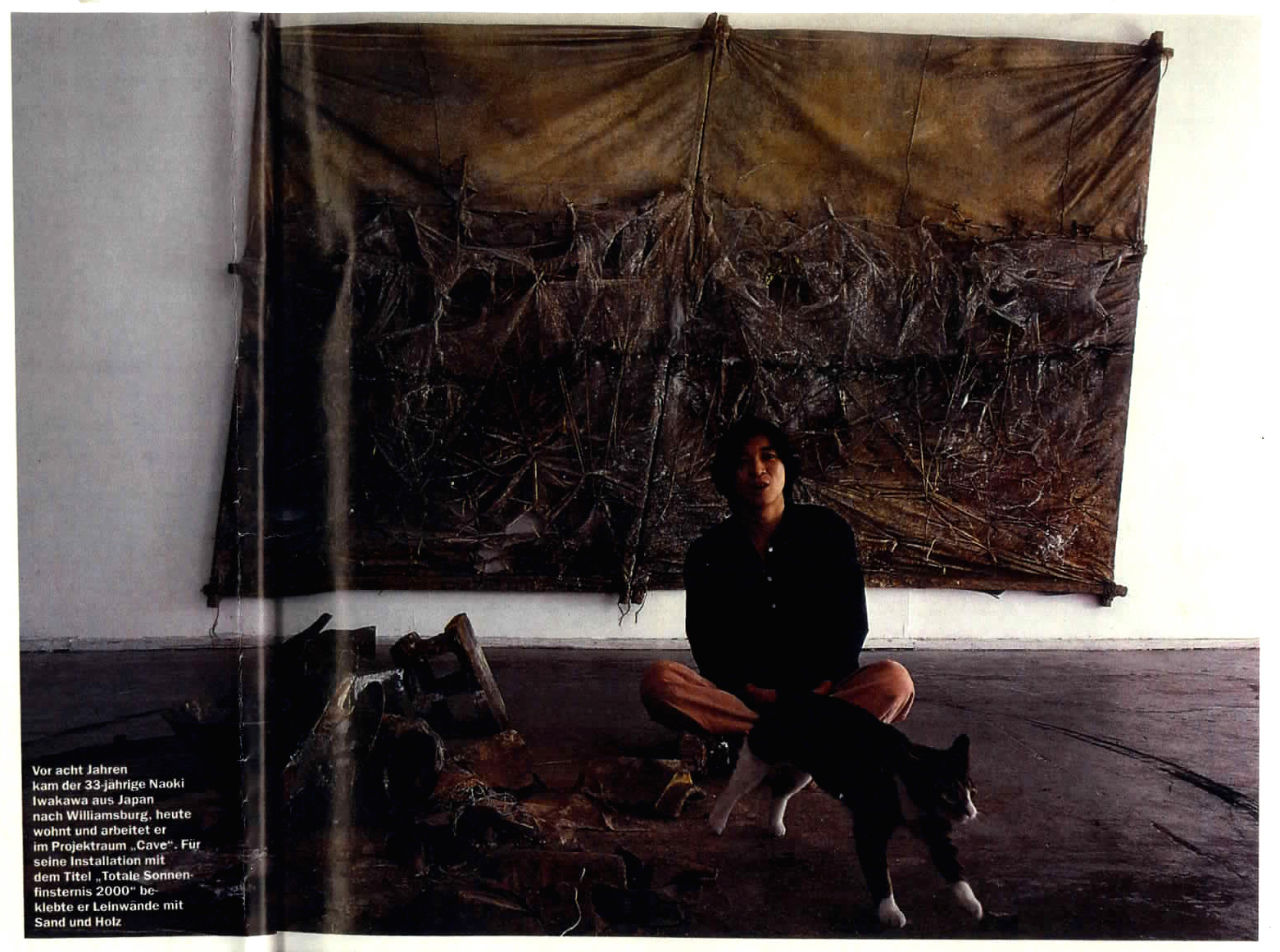 Naoki Iwakawa sitting in font of a canvas